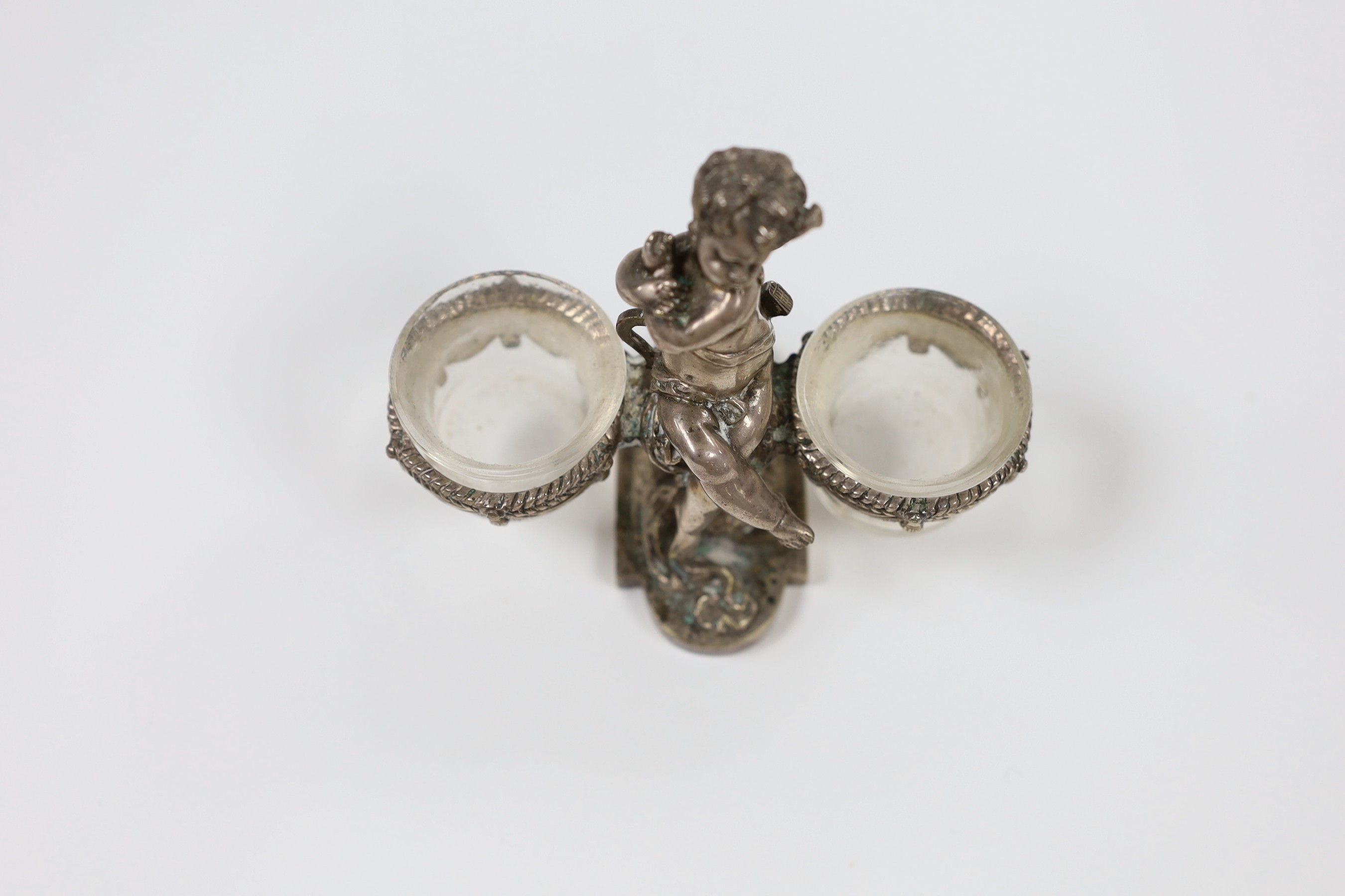 A Baccarat plated seated 'cherub' basket salt, 10cm tall